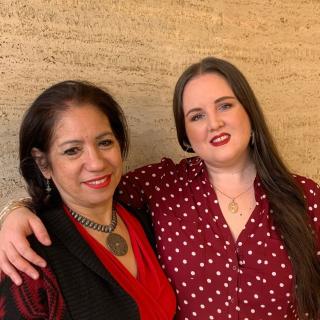 two women in red shirts with their arms around each other