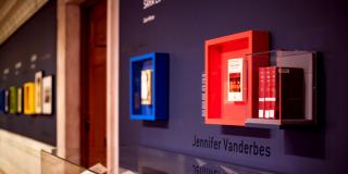 photograph of items framed on a wall over a vitrine