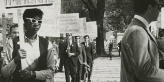 Ernestine Eckstein in a picket line with sign