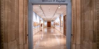 Photograph with fisheye view of exhibition showing both sides of the gallery corridor