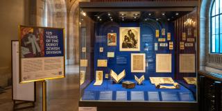 Photograph of the entire exhibition display case with the introduction panel next to it.