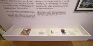 Close up image of archival materials in a lavender wall hanging display case