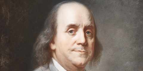 Portrait of Benjamin Franklin wearing a grey suit and vest, he has a thin tired smile