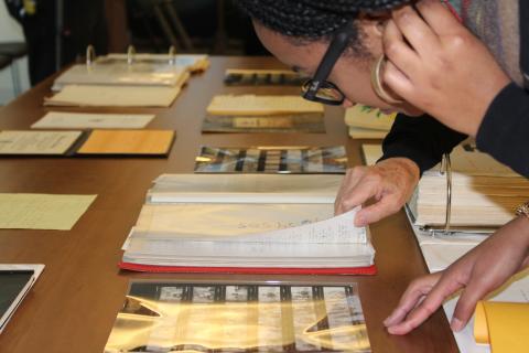 Color image of a person looking at archival collections