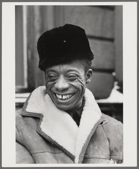 Black and White photo of a Black man in a shearling coat and a black furry hat