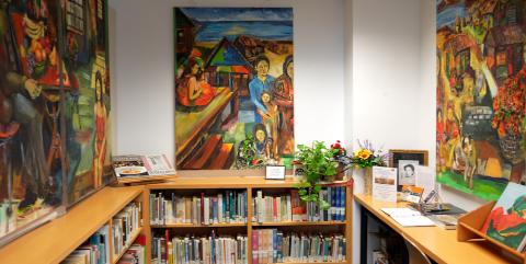 The Latino & Puerto Rican Cultural Center, featuring colorful art on the walls and shelves of books.